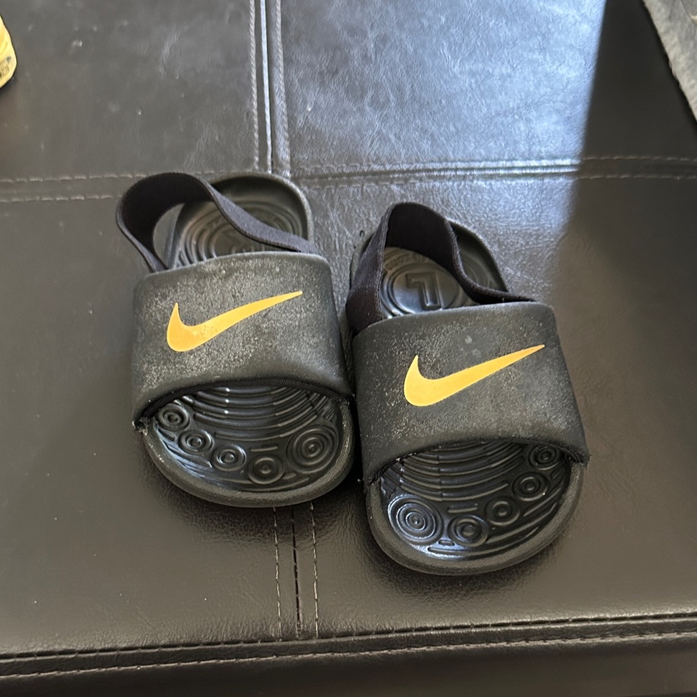 Nike Kids Black Sandals with Gold Swoosh